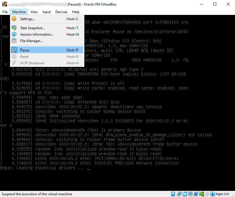 Same screenshot as above, except the VM is paused, and the 'Machine' menu is open with the 'Pause' option highlighted.